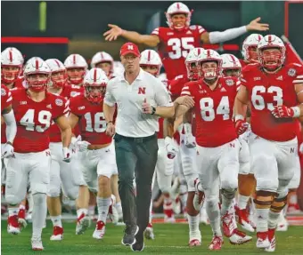  ?? AP PHOTO/NATI HARNIK ?? Nebraska football coach Scott Frost leads the Cornhusker­s onto the field for their season opener against Akron on Sept. 1 in Lincoln, Neb. Frost is suspicious of recent behavior by Oregon State football coaches.