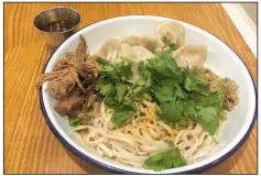  ?? Arkansas Democrat-Gazette/ELLIS WIDNER ?? The Half + Half Bowl at Three Fold Noodles + Dumpling Co. allows diners to combine half portions of two dumpling or noodle dishes.