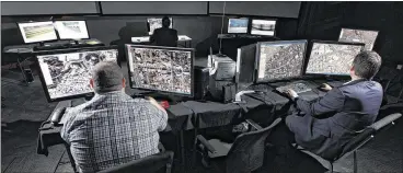  ?? TY GREENLEES / STAFF ?? Analysts Alex Blassingam­e (left) and Dan Waite look at aerial footage from Persistent Surveillan­ce Systems. The company, which has its roots in Dayton’s Tech Town, is testing its system in Baltimore.