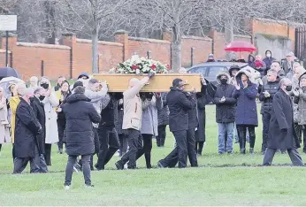  ??  ?? Leon Hetheringt­on’s coffin is carried to his grave at Bishopwear­mouth Cemetery, mourners clap in respect.