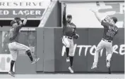  ?? JIM MCISAAC TNS ?? The Twins' Eddie Rosario, Byron Buxton and Max Kepler celebrate after the final out in a 7-3 win over the Yankees in New York on Saturday.