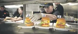  ?? Christian K. Lee Los Angeles Times ?? IMPOSSIBLE BURGERS are prepared Wednesday at an Umami Burger in L.A. The supplier of the meatless patties has raised $182 million in venture funding.