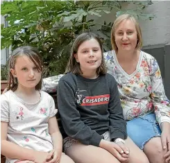  ?? BEJON HASWELL/STUFF ?? Cancer survivor Georgina Hamilton – with her children, Lucy, left 7, and Olivia 10, – says that news a life-prolonging breast cancer drug could soon be publicly funded is fantastic.