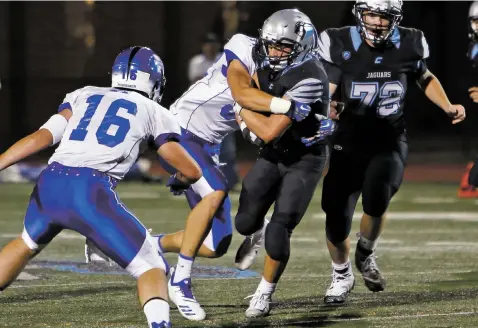  ?? PHOTOS BY LUIS SÁNCHEZ SATURNO/THE NEW MEXICAN ?? Capital’s Luke Padilla is tackled during a Sept. 14 game against St. Michael’s. The Horsemen routed the Jaguars 42-6. The Jaguars aren’t playing Friday, giving them an extra week to practice and allowing injured players to recuperate.