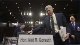  ?? SUSAN WALSH — ASSOCIATED PRESS ?? Supreme Court nominee Neil Gorsuch returns from a break Wednesday to continue his testimony on Capitol Hill.