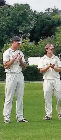  ??  ?? Paul and Chris Wood are applauded off after their superb stand of 107 unbroken for the ninth wicket for Marple at Bowdon at the weekend