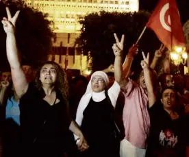  ?? REUTERS ?? TUNISIANS gather to protest the killing of opposition politician Mohamed Brahimi in Tunis on July 25.