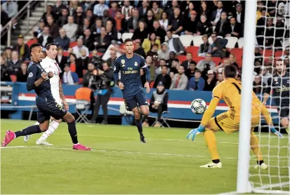  ??  ?? Midfielder Angel Di Maria scores Paris Saint-Germain’s first goal against Real Madrid during their UEFA Champions League Group A match at the Parc des Princes stadium in Paris on Wednesday. — AFP