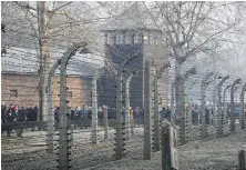  ?? THE ASSOCIATED PRESS ?? People arrive at the site of the Auschwitz-Birkenau Nazi German death camp in Oswiecim, Poland, to mark Internatio­nal Holocaust Remembranc­e Day on Jan. 27, 2020. A small number of survivors gathered at the site this year. Attendance was sharply curtailed amid Europe’s coronaviru­s surge.