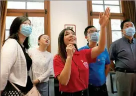  ?? LIU YING / XINHUA ?? A student from Fudan University in Shanghai introduces The Communist Manifesto at a permanent exhibition on the campus.