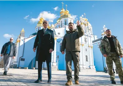  ?? EVAN VUCCI/AP ?? President Joe Biden walks with Ukrainian President Volodymyr Zelenskyy on Monday near a cathedral in a surprise visit to Kyiv.