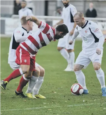  ??  ?? Gary Bradshaw tries to nick the ball away from the Trafford defence