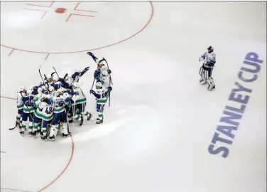  ?? The Canadian Press ?? Vancouver Canucks players celebrate their overtime win over the Minnesota Wild in Edmonton on Friday.
