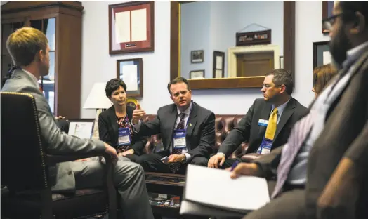  ?? Al Drago / New York Times ?? Hugh Chancy (center), owner of several Georgia pharmacies, speaks with the staff of Rep. Hank C. Johnson, D-Ga.