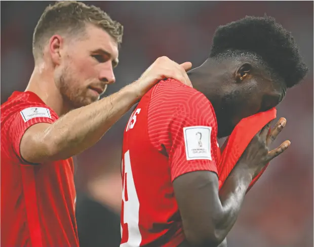  ?? MATTHIAS HANGST / GETTY IMAGES ?? David Wotherspoo­n, left. consoles Alphonso Davies on Thursday after Canada’s 2-1 loss to Morocco at the World Cup.