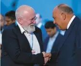  ?? PETER DEJONG/AP ?? The EU’s Frans Timmermans, left, and Sameh Shoukry, chief of the COP27 climate summit Sunday. Timmermans says a new deal doesn’t do enough to cut emissions.