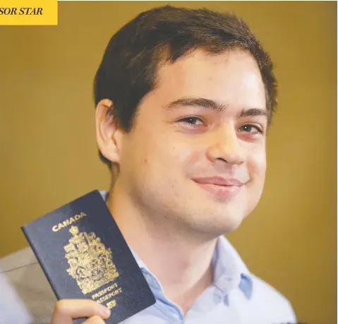  ?? CHRIS YOUNG / THE CANADIAN PRESS ?? Alexander Vavilov, the Canadian-born son of Russian spies, holds up his passport as he speaks to media in Toronto on Friday.
Vavilov’s Canadian citizenshi­p, and that of his brother Timothy, has been affirmed by the Supreme Court of Canada.
