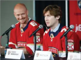  ?? WILFREDO LEE — THE ASSOCIATED PRESS ?? Newly acquired Florida Panthers player Anton Stralman, left, smiles as Sergei Bobrovsky speaks during an NHL hockey news conference Tuesday in Sunrise, Fla. The Panthers introduced Stralman, Bobrovsky, Brett Connolly and Noel Acciari.