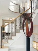  ??  ?? A grand split staircase in oak, with metallic chestnut spindles is the first thing you see when you walk in the front door.