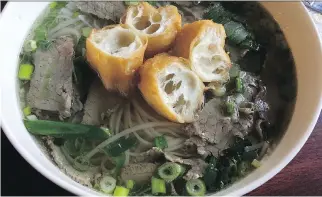  ?? PETER HUM ?? A steaming bowl of beef pho with fried dough at the three-month-old Chez Anh.