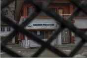  ?? DAR YASIN — THE ASSOCIATED PRESS ?? Kashmir Press Club building is pictured through a closed gate after it was sealed by authoritie­s in Srinagar, Indian controlled Kashmir, Tuesday.