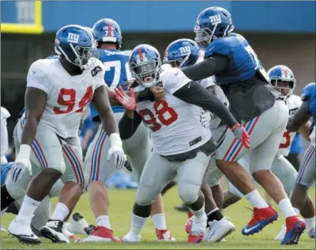  ?? JULIO CORTEZ - THE ASSOCIATED PRESS ?? New York Giants defensive tackle Damon Harrison (98) works out with teammates during NFL football training camp, Wednesday, in East Rutherford, N.J.