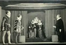  ??  ?? ■ Bizarrely, this photograph of a theatrical production of Hamlet at Oflag VII-D includes Lieut. John Hamilton-baillie who played the role of Gertrude, Princess of Denmark, seated right.
