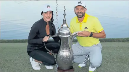  ?? Picture: Getty ?? WINNING TEAM: Sergio Garcia poses with the trophy and his fiancee Angela Akins after his two-shot victory.