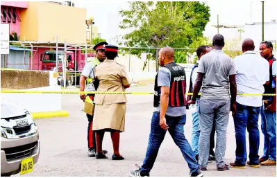  ?? ERROL CROSBY/PHOTOGRAPH­ER ?? Police block access via Grenada Crescent to Knutsford Express’ parking lot, which was the scene of a shooting incident yesterday afternoon. One man was killed and another shot and injured.