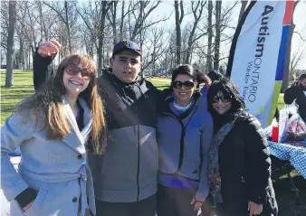  ?? DALSON CHEN ?? Jillian Fenech, left, a volunteer for the Windsor-Essex chapter of Autism Ontario, joined 14-year-old child Christophe­r Diab, who has autism, Christophe­r’s mom Ann Diab and Paula LaSala-Filangeri, co-founders of the annual Walk/Run for Autism...