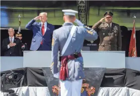  ?? JOHN MINCHILLO/AP ?? President Donald Trump, left, and U.S. Military Academy Superinten­dent Darryl A. Williams, right, salute alongside graduating cadets as the national anthem is played during commenceme­nt ceremonies on Saturday.