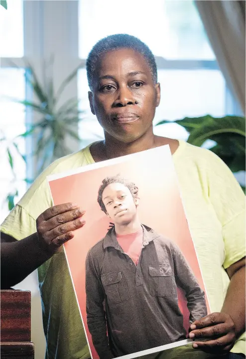  ?? DARREN BROWN / POSTMEDIA NEWS ?? Maureen Henry holds a photograph of her son Dovi, who was found dead and without ID in Lake Ontario in 2014. Henry believes Dovi’s digital footprint in his final weeks and days could provide informatio­n about his death.