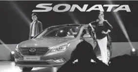  ?? LEE JIN-MAN/ THE ASSOCIATED PRESS ?? Models pose next to Hyundai’s all-new Sonata sedan during its unveiling ceremony in Seoul on Monday. The vehicle is scheduled to go on sale in South Korea later this month.