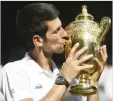  ??  ?? Novak Djokovic kisses Wimbledon 2018 trophy