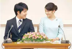 ?? — Reuters ?? Princess Mako, the elder daughter of Prince Akishino and Princess Kiko, and her fiancee Kei Komuro, a university friend of Princess Mako, smile during a press conference to announce their engagement at Akasaka East Residence in Tokyo.