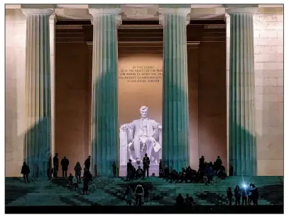  ?? The Washington Post/BONNIE JO MOUNT ?? Visitors gather at the Lincoln Memorial at dusk. The setting sun (and fewer crowds) make this a perfect time to visit the popular site.