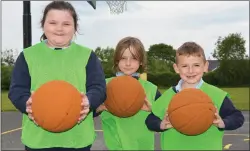  ??  ?? Lilly May, Dáire and AJ putting their basketball skills to the test on Friday morning.