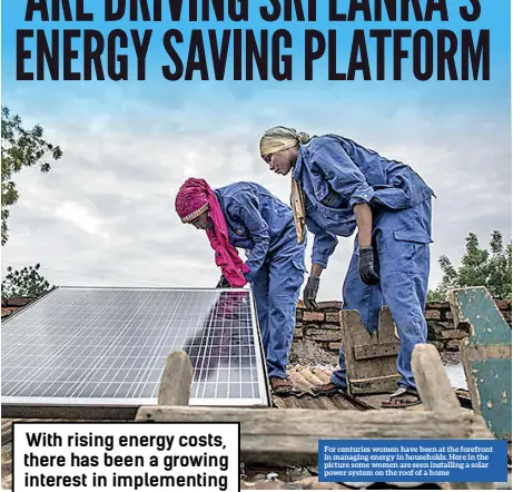  ?? ?? For centuries women have been at the forefront in managing energy in households. Here in the picture some women are seen installing a solar power system on the roof of a home