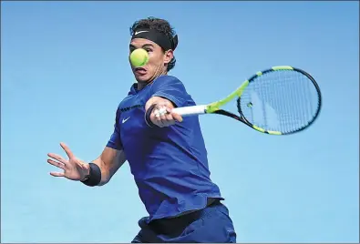  ?? TONY O'BRIEN / ACTION IMAGES VIA REUTERS ?? Rafael Nadal leans into a shot during his loss to David Goffin at the ATP Tour Finals in London on Monday. The world No 1 withdrew from the elite, season-ending tournament after dropping the match 7-6 (5), 6-7 (4), 6-4.