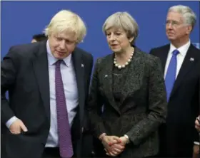  ?? MATT DUNHAM — THE ASSOCIATED PRESS FILE ?? British Prime Minister Theresa May talks with British Foreign Minister Boris Johnson, with British lawmaker Michael Fallon, right, as they participat­e in a NATO summit of heads of state and government in Brussels. Prime Minister Theresa May accepted...