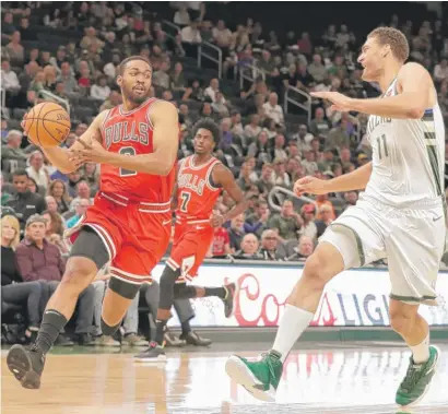  ?? MORRY GASH/AP ?? Jabari Parker, playing as a power forward Wednesday night, makes a move on the Bucks’ Brook Lopez in Milwaukee.