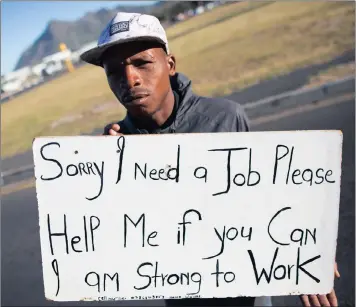  ?? PICTURE: NIC BOTHMA / EPA ?? DESPERATIO­N: An unemployed man holds a self-made advertisin­g board offering his services as youth unemployme­nt is at a record high.
