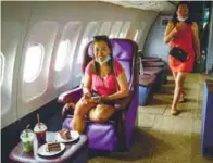  ??  ?? Visitors enjoying business class seats in a retired Airbus 330 air-plane turned into a coffee shop at an attraction site, outside Pattaya in Chonburi province.