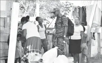  ??  ?? Lieutenant Colonel Kester Craig interacts with residents (DPI photo)