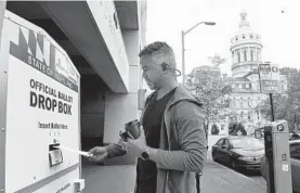  ?? BARBARA HADDOCK TAYLOR/BALTIMORE SUN ?? Jose Jimenez puts his ballot in the drop box outside Baltimore’s Board of Elections office.