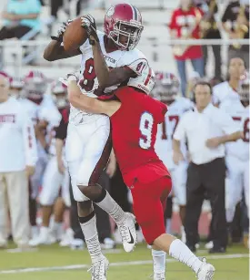  ?? STAFF PHOTOS BY NICOLAUS CZARNECKI ?? CLOSE COMPETITIO­N: Brockton’s Ademola Faleye makes a catch while being hit by Natick’s Max Ferrucci during the Boxers’ 22-20 victory last night; below, Brockton’s Ajani Horne carries the ball as he tries to avoid Natick’s Hunter Ferrera.