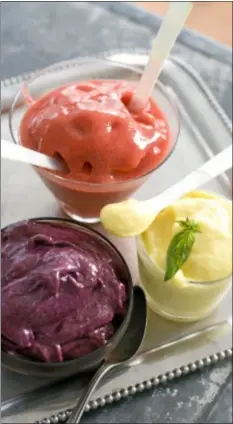  ??  ?? Creamy Blueberry Banana (left), Strawberry Lime, and Tropical Mango Banana soft serve fruits are shown in dessert dishes. (AP Photo)