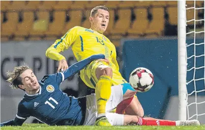  ?? Picture: SNS. ?? Ukraine’s Ivan Zotko gets back to prevent Scott Wright sliding in a goal for Scotland.