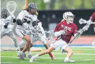  ?? AAron Ontiveroz, The Denver Post ?? Cole Mika, left, of Cheyenne Mountain defends Golden’s Ben Kirschner during the first half Monday night at All-City Stadium during the Class 4A lacrosse state championsh­ip game.