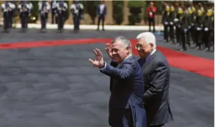  ?? (Mohamad Torokman/Reuters) ?? JORDAN’S KING Abdullah II and Palestinia­n Authority President Mahmoud Abbas wave during a reception ceremony in Ramallah yesterday.